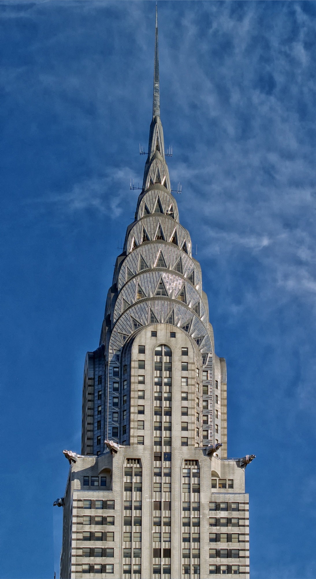 The Chrysler Building's crown and spire against a blue sky, New York City